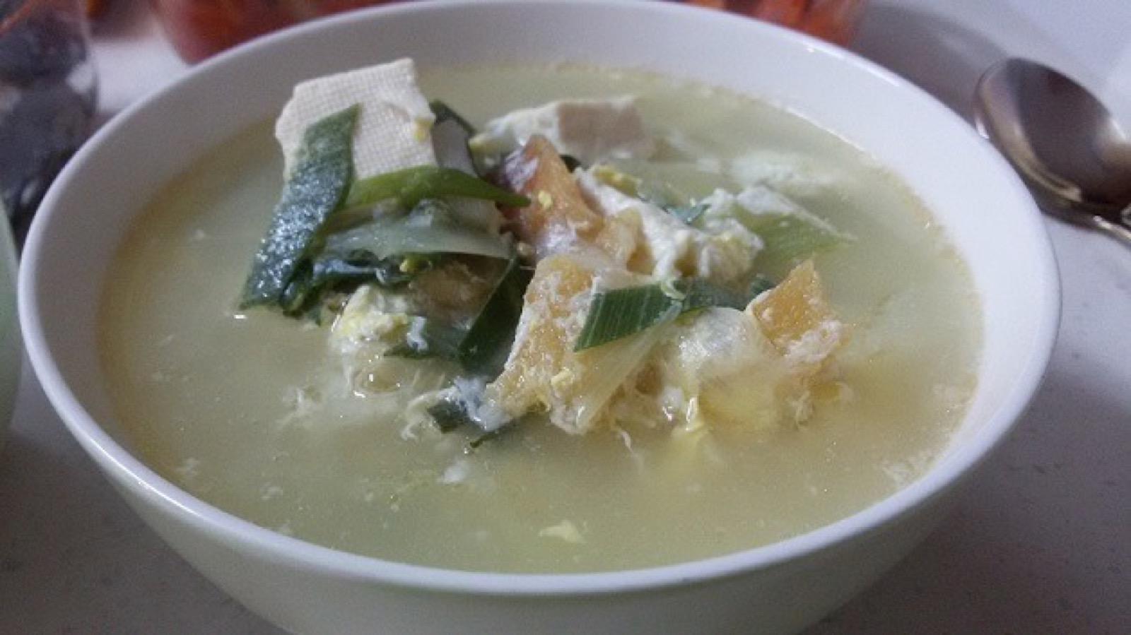 A bowl of Korean dried pollack soup in a clear broth