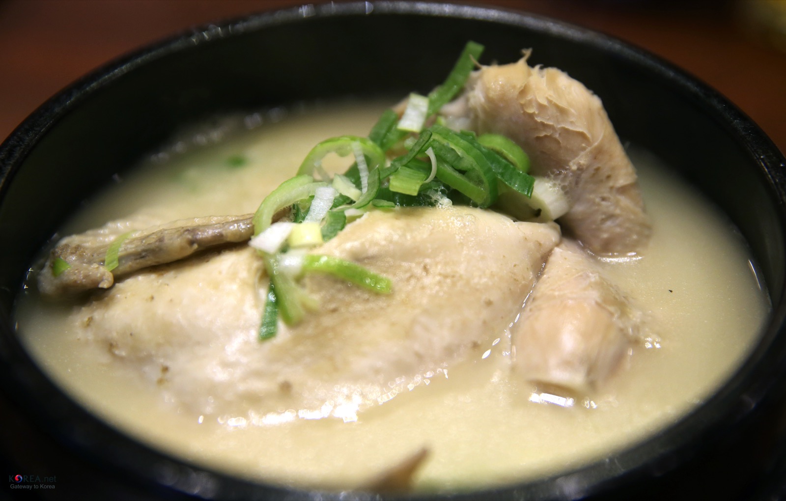 A bowl of samgyetang with chicken and rich broth
